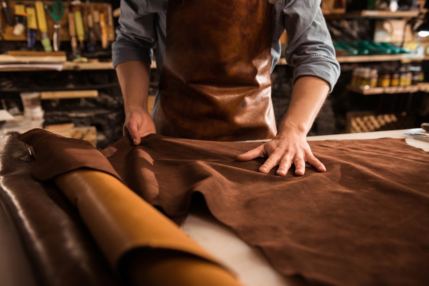 Person working with leather in a workshop setting - Westo Leather